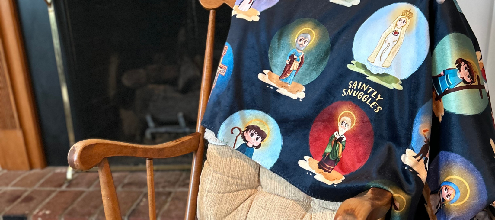 Blanket with cartoon characters draped over a wooden chair in a cozy room.