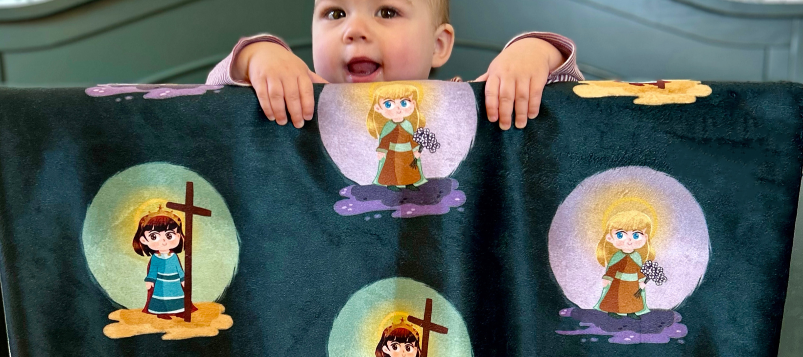 Child holding a blanket with cartoon characters on it